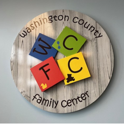 photo of logo for the washington county family center on wooden block