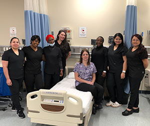 students stand together near a hospital bed