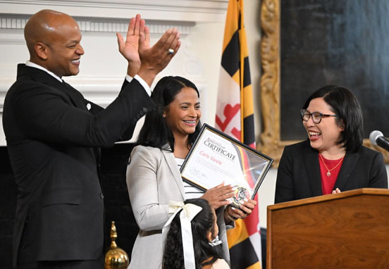 Governor Wes Moore and Maryland Department of Labor Secretary Portia Wu with a Registered Apprenticeship graduate